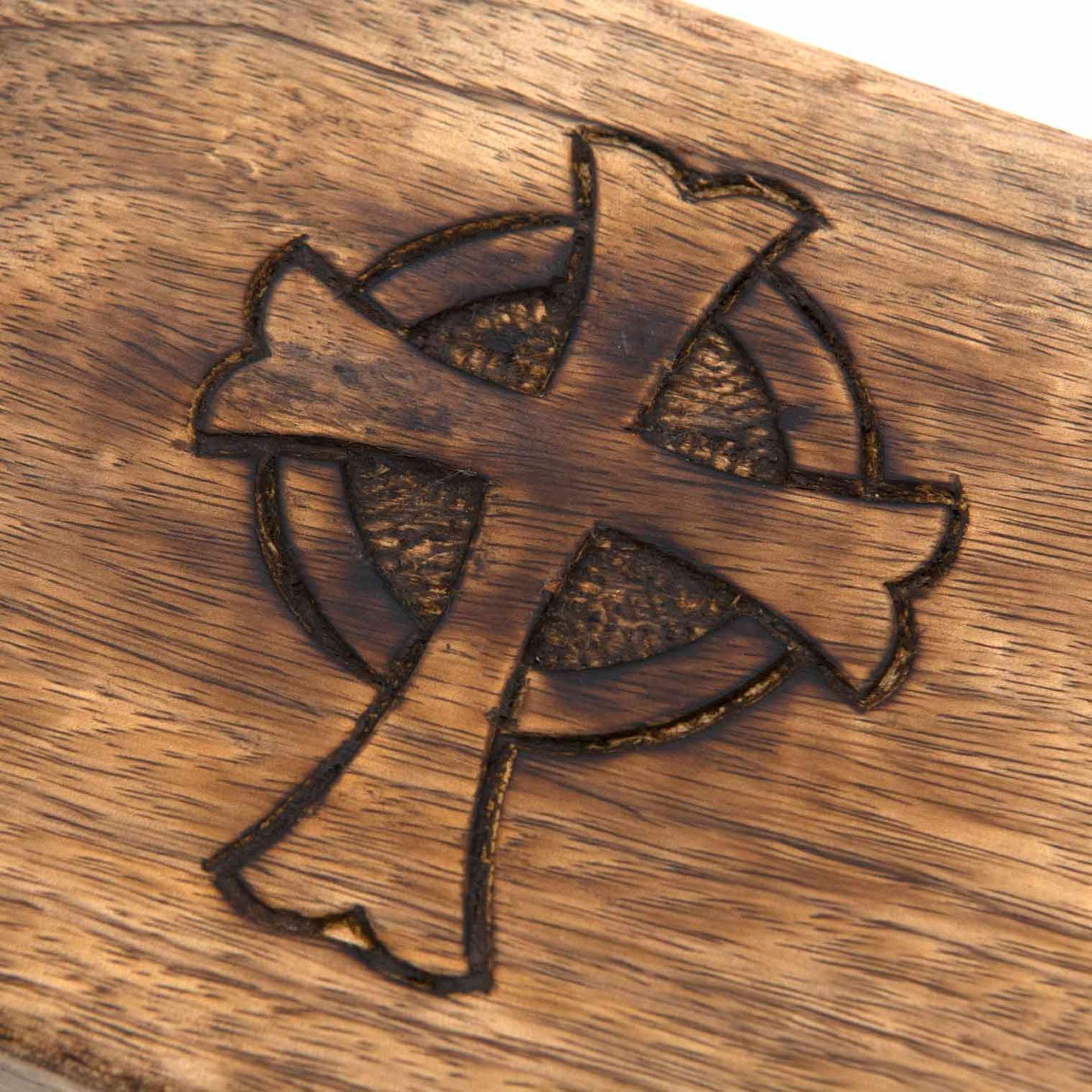 Close-up detail of Celtic cross engraving on mango wood box lid, India