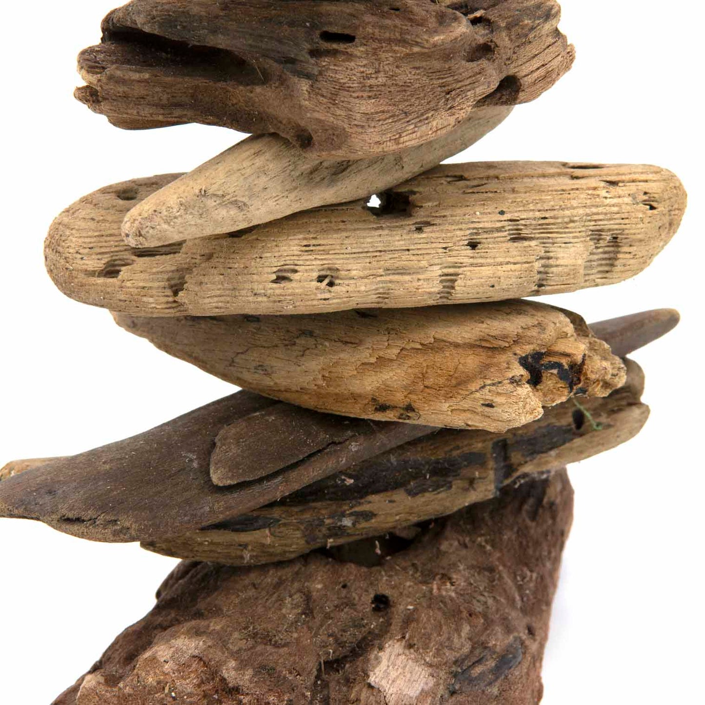 Detail of stacked driftwood base showing weathered grain and varied piece shapes