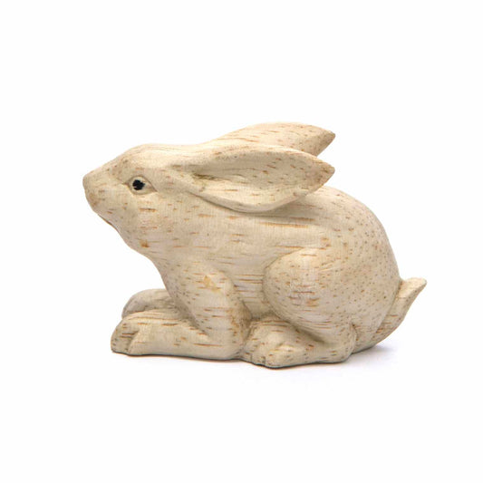 Small carved rabbit figurine, side view showing swept-back ears and fine grain, Indonesia
