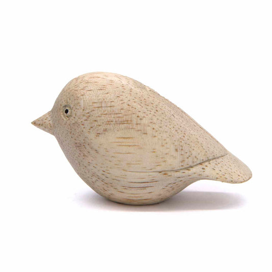 Mini pale wood bird carving, side view showing smooth egg-shaped body and short bill, Indonesia