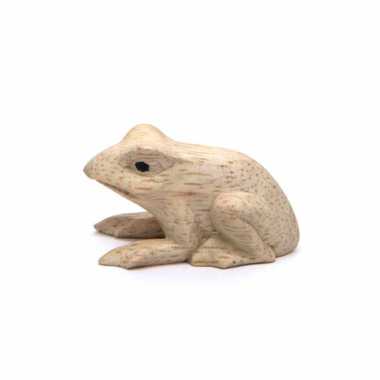 Mini pale wood frog carving, side view showing crouched form and fine grain, Indonesia