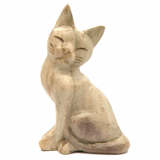 Pale wood sitting cat carving, three-quarter front view showing closed eyes and sharp ears