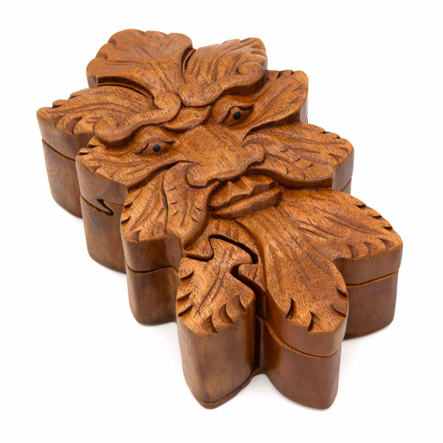 Carved wood Green Man puzzle box from Bali showing interlocking leaf-shaped lid sections and deeply carved face with acanthus