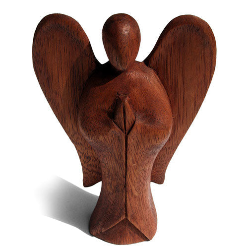 Abstract wooden angel carving with broad curved wings, front view on white background