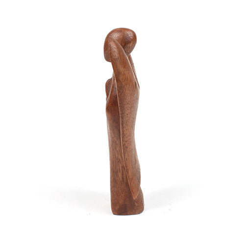 Side profile of small abstract Balinese wood angel carving showing elongated form
