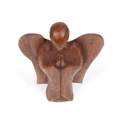 Low-set abstract wooden angel carving with wide spread wings, front view