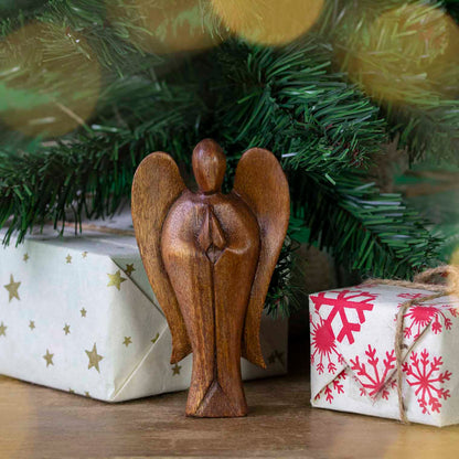 Hand-carved Balinese abstract angel figurine displayed beneath a Christmas tree, Indonesia
