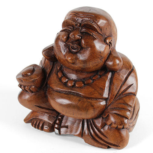 Carved wood Budai figure, three-quarter view showing robe folds and warm grain, Indonesia
