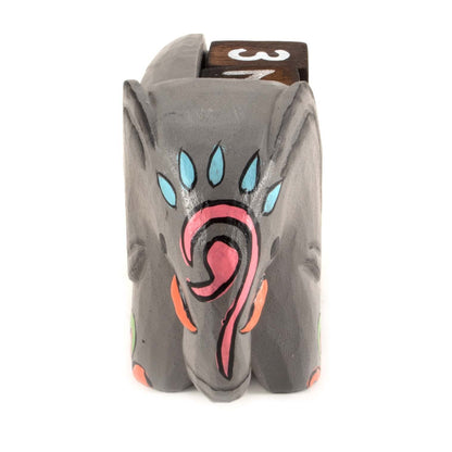 Front view of painted wooden elephant calendar showing curled trunk and blue teardrop detail