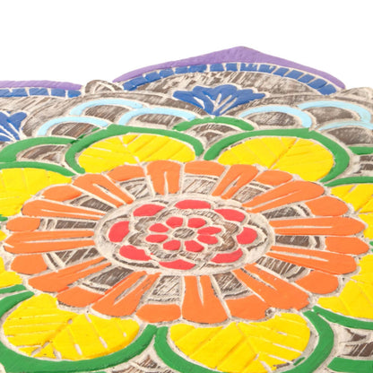Detail of mandala plaque centre showing hand-painted orange and red petals with raw wood grain between carved sections