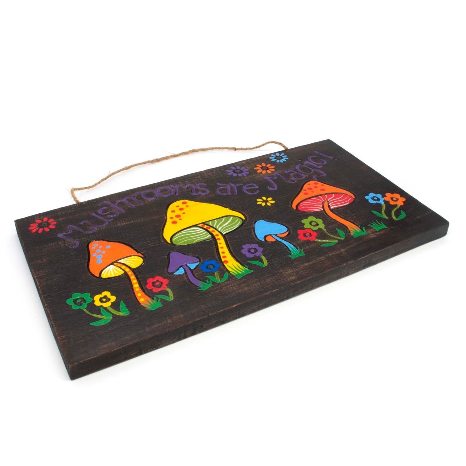 Angled side view of Mushrooms Are Magic wood sign showing plank thickness and twine hanger, Indonesia