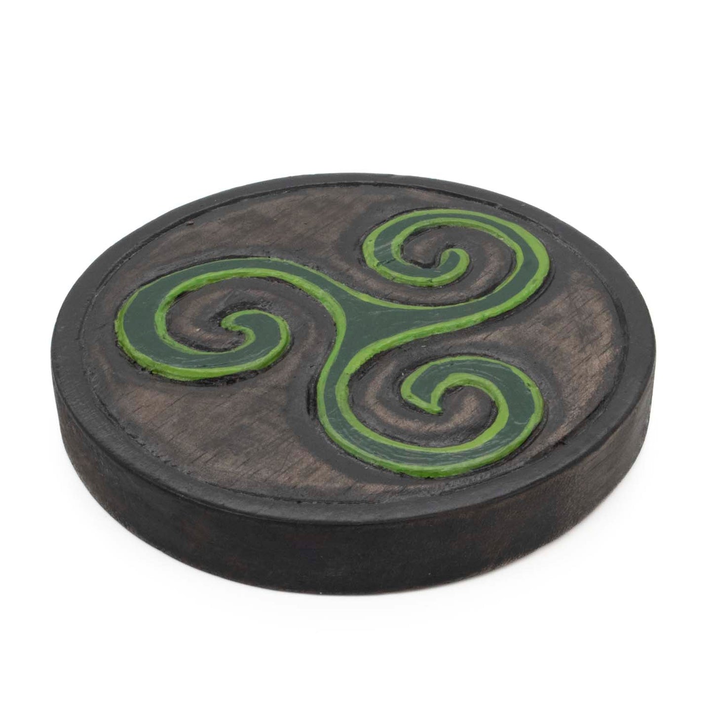 Angled side view of mini triskelion plaque showing carved disc depth and dark-painted edge, Indonesia
