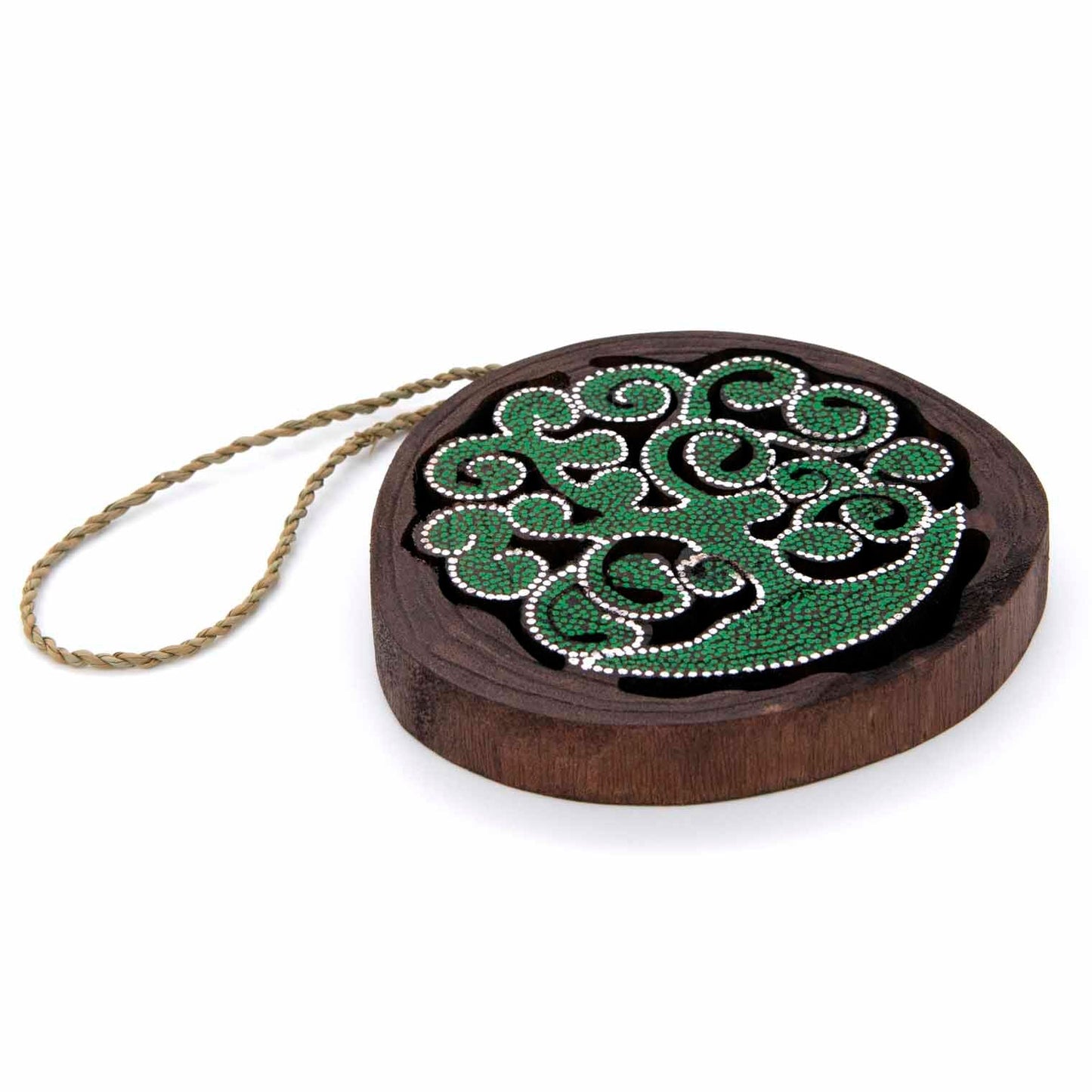 Angled side view of dot-painted cutaway tree of life disc showing wood depth and braided twine hanger