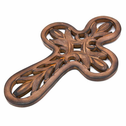 Carved mango wood cross plaque at an angle showing depth of relief carving and dark brown finish