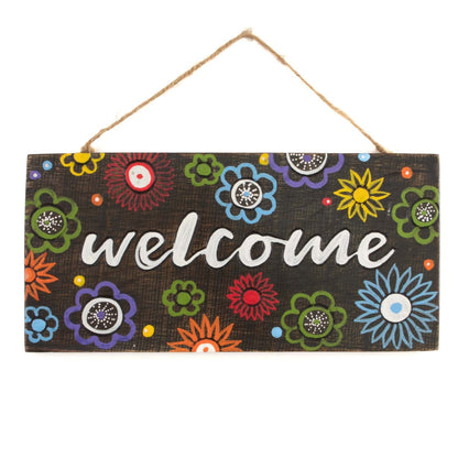 Front view of Welcome plaque on white background, showing carved white lettering and full scatter of hand-painted flowers