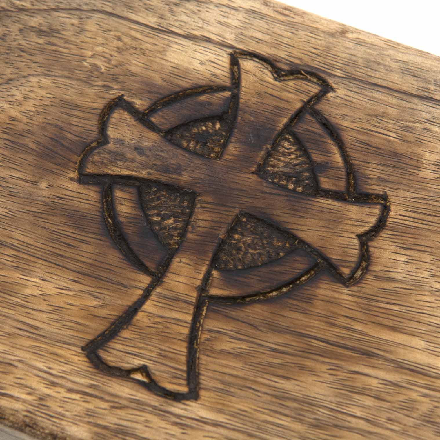 Close-up detail of Celtic cross engraving on mango wood box lid, India