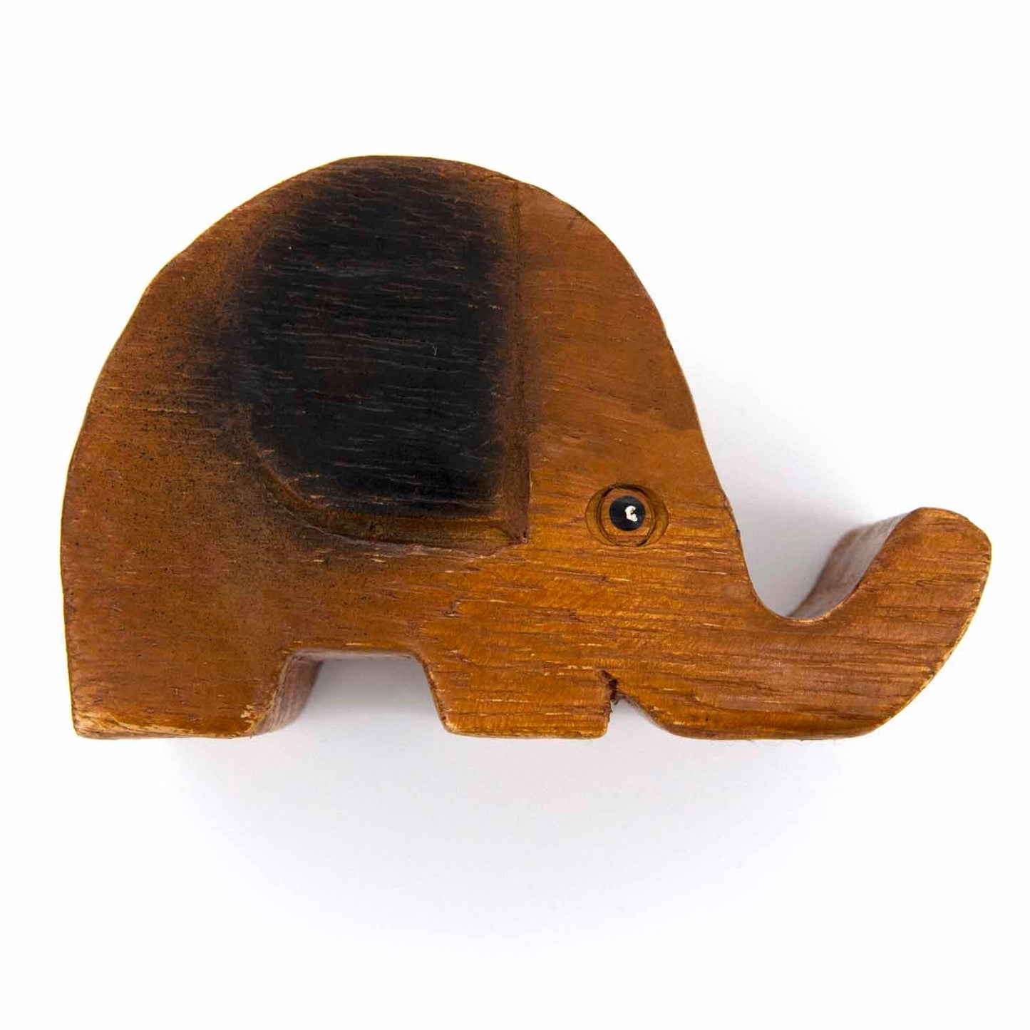 Top-down view of carved wooden elephant phone stand showing ear detail and grain, white background