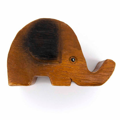 Top-down view of carved wooden elephant phone stand showing ear detail and grain, white background