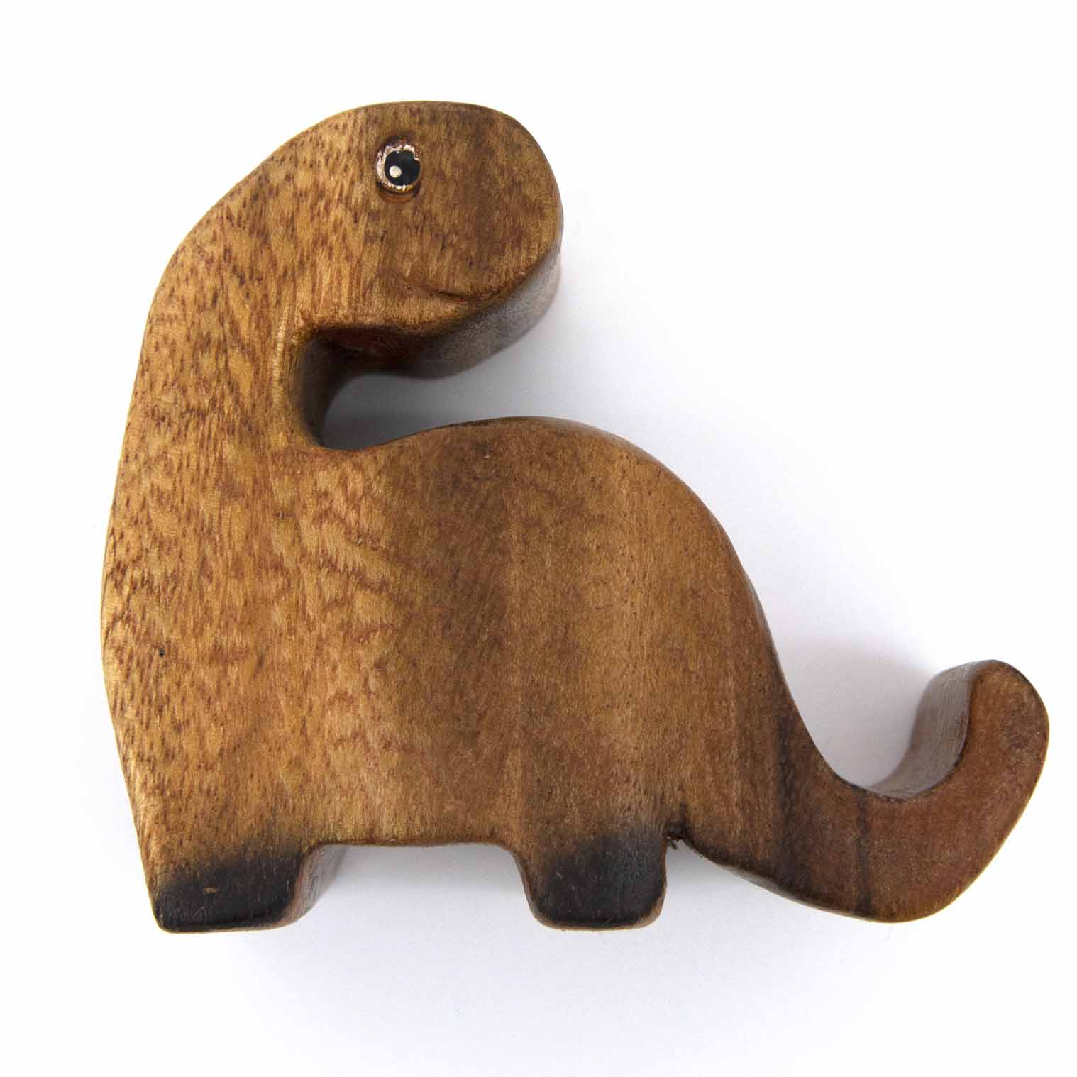 Top-down view of carved hardwood dinosaur phone stand showing neck slot and amber grain, white background