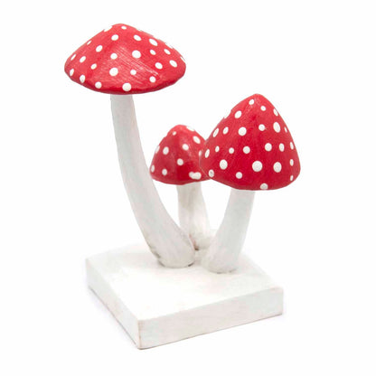 Carved wooden fly agaric cluster, three-quarter side view showing varying stem heights, Indonesia