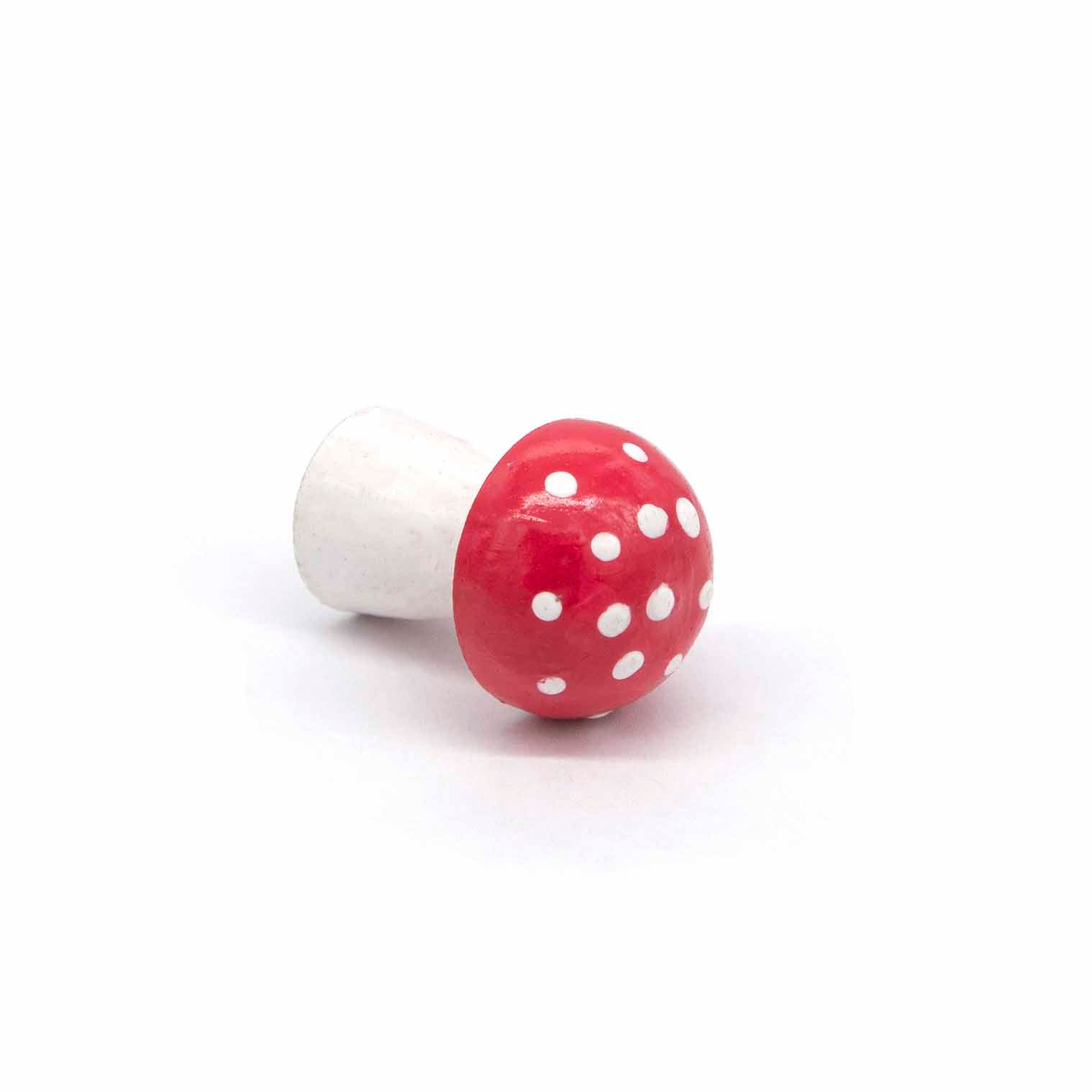 Mini wooden fly agaric mushroom lying on its side showing spotted cap detail, Indonesia