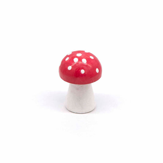 Small hand-painted wooden toadstool, red cap with white spots on white stem, front view on white