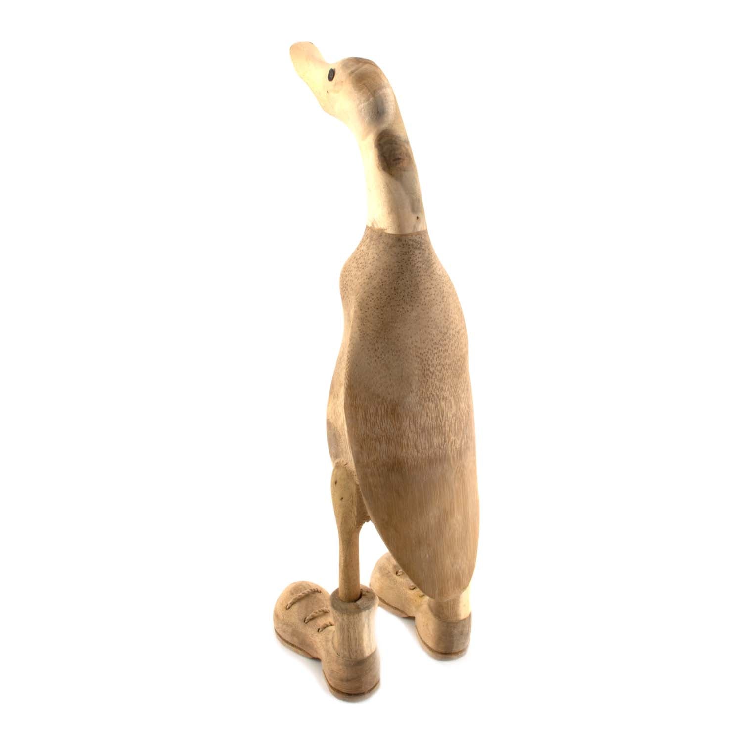 Rear view of natural bamboo root duck showing pale unvarnished body and carved boot detail
