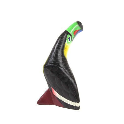 Wooden toucan sculpture, rear three-quarter view showing black wing and coloured bill