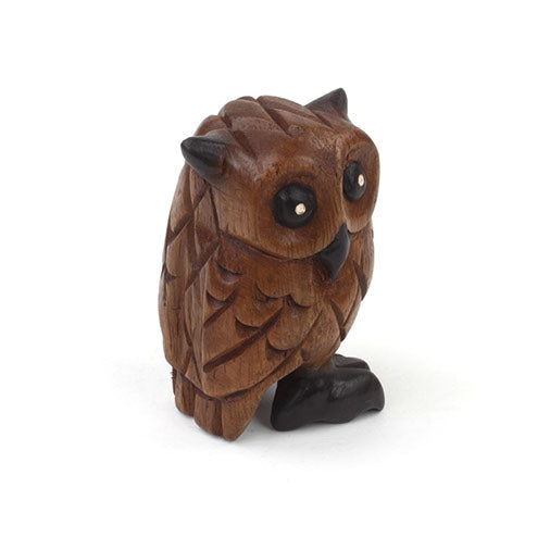 Acacia wood owl carving, three-quarter side view showing wing and feather texture, northern Thailand