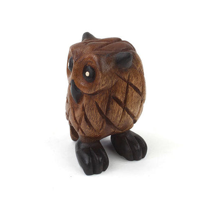 Small carved wooden owl from above and front, showing rounded body and dark eye detail