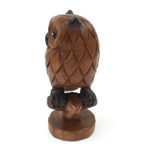 Acacia wood owl carving, three-quarter rear view showing back feather pattern and branch perch
