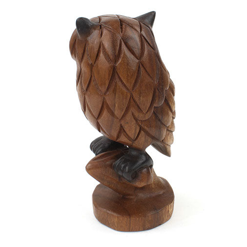 Side view of carved acacia owl on branch showing profile, feather layers and turned wooden base