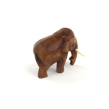 Mini Raintree elephant carving, head-on view showing trunk and tusks, northern Thailand