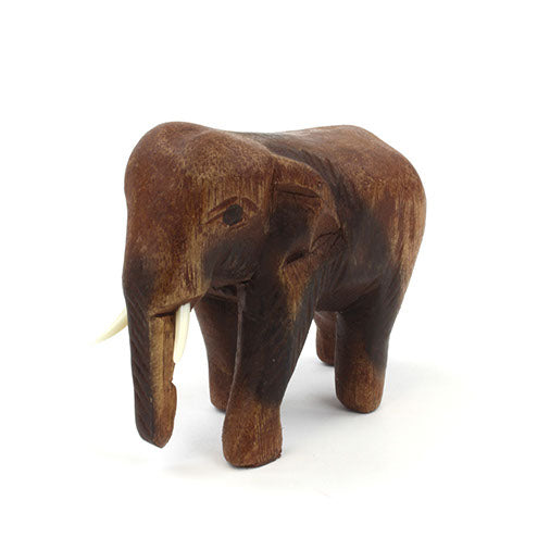 Small Raintree elephant carving showing trunk and tusk detail, front three-quarter view