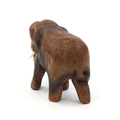 Rear view of small hand-carved Raintree elephant showing smooth back and tail, Thailand