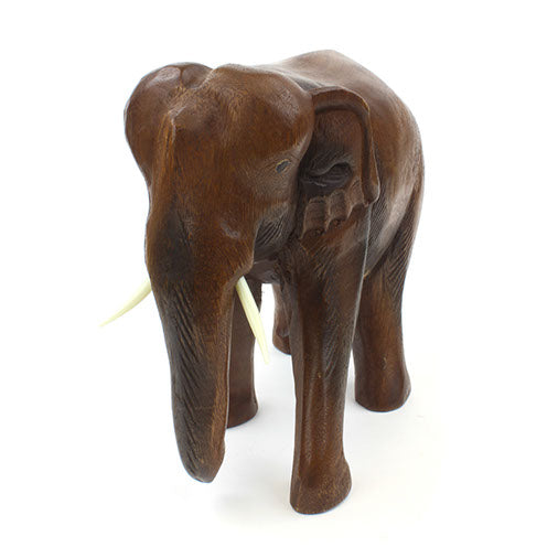 Large Raintree elephant carving, front three-quarter view with trunk detail and dark-stained passages