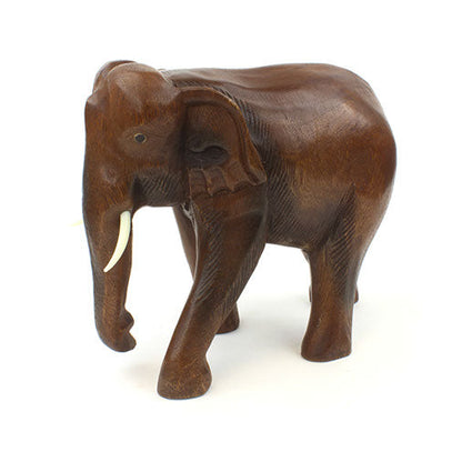 Large carved wooden elephant in Raintree, side profile showing smooth back and defined ear, white background