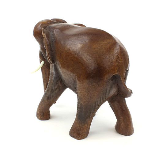 Rear view of large hand-carved Raintree elephant showing rounded haunches and tail, white background