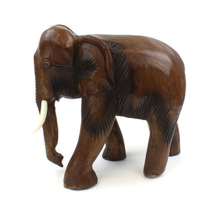 Extra large Raintree elephant carving, three-quarter side view showing feather-carved body texture, Thailand
