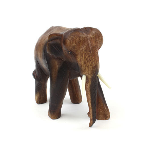 Medium Raintree elephant carving, front three-quarter view with trunk lowered and tusks prominent