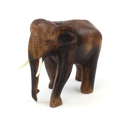 Carved Raintree elephant, side profile showing broad domed head and defined ear, white background