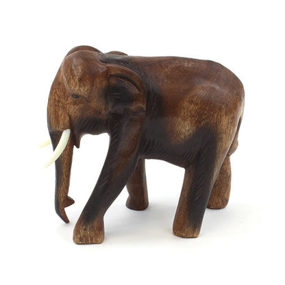 Medium carved wooden elephant in Raintree, facing right, showing body grain and leg form, Thailand