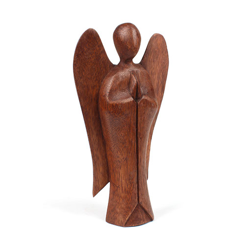 Three-quarter view of large abstract Raintree angel carving showing wing depth, Indonesia