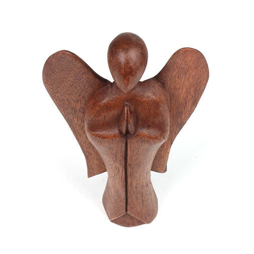 Low-angle front view of large abstract Raintree wood angel, Indonesia