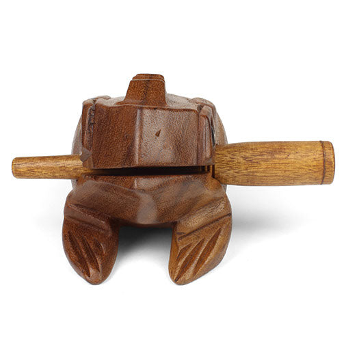 Front view of medium carved frog guiro from below showing carved feet and hollow underside