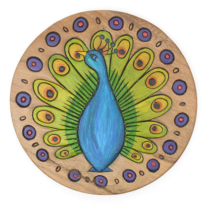 Top-down view of Raintree wood stool seat showing carved peacock with full fan tail, orange-eyed feathers and blue body, Thai
