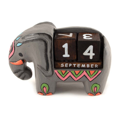 Painted wooden elephant calendar with rotating date blocks showing September, side view on white