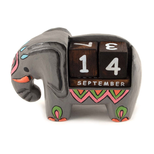 Painted wooden elephant calendar with rotating date blocks showing September, side view on white