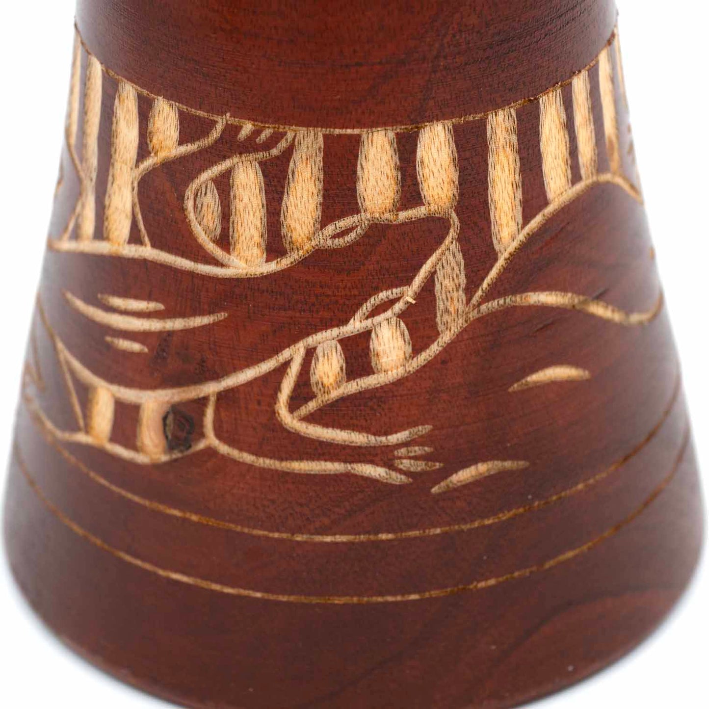 Close-up of carved gecko motif on djembe drum base showing striped skin texture in pale wood against dark stain, Indonesia