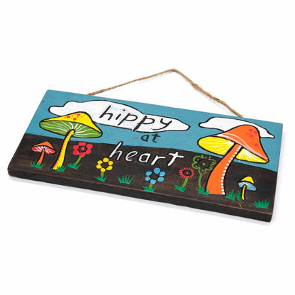 Angled side view of Hippy at Heart plaque showing carved wood depth and hand-painted toadstool and flower detail